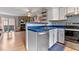 Open-concept kitchen with breakfast bar flowing into living area with stone fireplace at 1035 Milo Cir # B, Lafayette, CO 80026