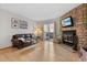 Cozy living room with stone fireplace and sliding glass doors to outdoor space at 1035 Milo Cir # B, Lafayette, CO 80026