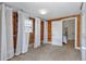 Bedroom with wood paneling, carpeted floor, and closet with white curtains at 4079 S Bannock St, Englewood, CO 80110