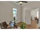Bright bedroom featuring hardwood floors, a ceiling fan, and an ensuite entrance at 4079 S Bannock St, Englewood, CO 80110