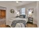 Cozy bedroom featuring stylish decor, natural light, and hardwood floors at 4079 S Bannock St, Englewood, CO 80110