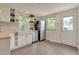 Charming kitchen features stainless appliances, farmhouse sink, and access to backyard at 4079 S Bannock St, Englewood, CO 80110