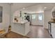 Kitchen with white cabinets, breakfast bar, stainless appliances, and access to back door at 4079 S Bannock St, Englewood, CO 80110
