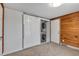 Laundry room with stacked washer and dryer and wood paneled wall at 4079 S Bannock St, Englewood, CO 80110
