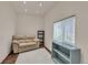 Living room with off-white couch and rug, a window, and painted blue shelving at 4079 S Bannock St, Englewood, CO 80110