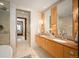 Luxurious bathroom with marble walls, double vanity, and a separate tub, with natural light from the bedroom beyond at 1133 14Th St # 2300, Denver, CO 80202