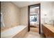 Relaxing bathroom boasts a soaking tub with mosaic tile surround and a stunning city view at 1133 14Th St # 2300, Denver, CO 80202