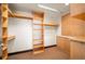 Spacious walk-in closet with custom shelving and ample storage space with wood trim at 1133 14Th St # 2300, Denver, CO 80202