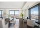 Elegant dining room with large windows offering panoramic city views and lots of natural light at 1133 14Th St # 2300, Denver, CO 80202