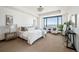 Serene main bedroom with a city view, comfortable seating area, and neutral decor at 1133 14Th St # 2300, Denver, CO 80202