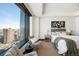 Stunning main bedroom features cityscape views from the large windows and stylish decor at 1133 14Th St # 2300, Denver, CO 80202