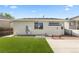 Spacious backyard with artificial turf and partial patio, perfect for outdoor enjoyment at 2034 Espana Way, Aurora, CO 80011