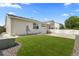 Well-maintained backyard featuring a manicured lawn and a partial view of a white fence at 2034 Espana Way, Aurora, CO 80011