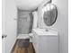 Stylishly updated bathroom featuring tiled shower and large mirror at 2034 Espana Way, Aurora, CO 80011