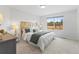 Cozy bedroom with a large window, plush carpeting, and a comfortable bed at 2034 Espana Way, Aurora, CO 80011