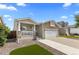 Inviting home showcasing a cozy front porch and a neatly maintained front yard at 2034 Espana Way, Aurora, CO 80011