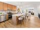 Spacious kitchen with an island, stainless steel appliances, and an open view to the living room at 2034 Espana Way, Aurora, CO 80011