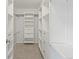 Walk-in closet featuring custom shelving, drawers, and ample storage space at 2034 Espana Way, Aurora, CO 80011
