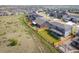 Aerial view of a home showcasing a fenced backyard with pergola and landscaping, bordering an open field at 14391 Shasta Daisy Pt, Parker, CO 80134
