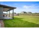 Expansive backyard with a covered patio and a well-manicured lawn, offering privacy and outdoor enjoyment at 14391 Shasta Daisy Pt, Parker, CO 80134