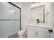 Stylish bathroom featuring glass shower doors, white cabinets, a toilet, and updated fixtures at 14391 Shasta Daisy Pt, Parker, CO 80134