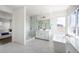 Modern bathroom featuring a soaking tub, glass shower, white cabinets and lots of natural light at 14391 Shasta Daisy Pt, Parker, CO 80134