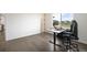 Modern bedroom with wood flooring, home office area and abundant natural light at 14391 Shasta Daisy Pt, Parker, CO 80134