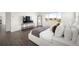 Bright bedroom featuring a large window, stylish decor, and hardwood floors at 14391 Shasta Daisy Pt, Parker, CO 80134