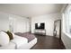 Bright, spacious bedroom featuring a large window, modern decor, and hardwood floors at 14391 Shasta Daisy Pt, Parker, CO 80134