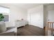 Cozy bedroom with hardwood floors and a white dresser, bathed in natural light at 14391 Shasta Daisy Pt, Parker, CO 80134