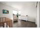 Sunlit Bedroom with a crib, soft armchair, and white dresser with changing pad at 14391 Shasta Daisy Pt, Parker, CO 80134