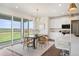 Bright eat-in kitchen featuring a center island, modern lighting, stainless appliances, and sliding door to backyard at 14391 Shasta Daisy Pt, Parker, CO 80134