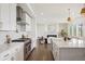 Bright, modern kitchen with an island, stainless steel appliances, and an open view into the living room at 14391 Shasta Daisy Pt, Parker, CO 80134