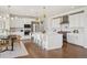 Bright eat-in kitchen with island seating, stainless appliances, and modern lighting adjacent to dining area at 14391 Shasta Daisy Pt, Parker, CO 80134