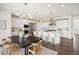 Bright kitchen with island, pendant lighting, stainless steel appliances, and dining area at 14391 Shasta Daisy Pt, Parker, CO 80134