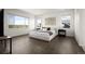 Serene primary bedroom with hardwood floors, neutral color scheme, and expansive windows with scenic views at 14391 Shasta Daisy Pt, Parker, CO 80134