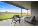 Covered patio featuring comfortable seating, overlooking a spacious, well-maintained lawn at 14391 Shasta Daisy Pt, Parker, CO 80134
