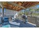 Outdoor covered deck features a grill, chairs, and lattice accents, perfect for relaxing or entertaining at 18890 E Carmel Cir, Aurora, CO 80011