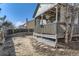 Backyard view showcases a covered deck, fence, and some landscaping opportunities at 18890 E Carmel Cir, Aurora, CO 80011