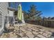 Backyard patio area with a patio table, chairs, umbrella, and a covered deck, great for outdoor enjoyment at 18890 E Carmel Cir, Aurora, CO 80011