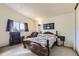 Cozy bedroom featuring a decorative wooden bed frame and a bright window at 18890 E Carmel Cir, Aurora, CO 80011