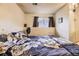 Small bedroom with a patterned comforter, a window, and a fan for cooling in a vintage style at 18890 E Carmel Cir, Aurora, CO 80011