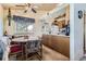 Charming dining area with a ceiling fan and window with valance, adjacent to the kitchen at 18890 E Carmel Cir, Aurora, CO 80011