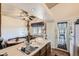 Bright eat-in kitchen with a sink, a door to the deck, and updated ceiling fixtures at 18890 E Carmel Cir, Aurora, CO 80011