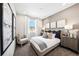 Comfortable bedroom featuring plush carpet, natural light, accent pillows, and neutral decor at 3379 N Denali St, Aurora, CO 80019