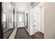Bright home entryway with hardwood floors, white door and trim, mirrors, and modern light fixture at 3379 N Denali St, Aurora, CO 80019