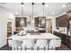 Modern kitchen features a large island with seating and pendant lighting at 3379 N Denali St, Aurora, CO 80019