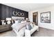 Elegant main bedroom with stylish accent wall, plush carpet and en suite bathroom at 3379 N Denali St, Aurora, CO 80019