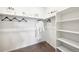 Bright, carpeted walk-in closet with white shelves and storage at 3379 N Denali St, Aurora, CO 80019