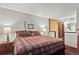Spacious bedroom offers a comfortable bed with side tables and lamps, with neutral-colored walls at 107 N Harris St # 306, Breckenridge, CO 80424
